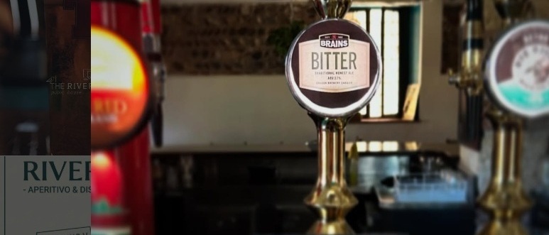 Interno del pub con arredi in legno e atmosfera britannica